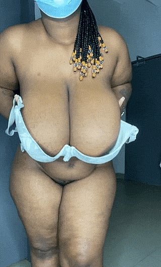 Let 'Em Out: A Busty Woman Exposes Her Large Breasts'