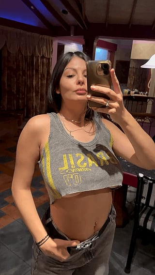 A Nice Reveal: Woman Takes Selfie in Tank Top'