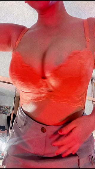 Showing off my tits in a bright orange bra'