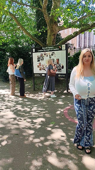 Big Tits Alert: Woman with Huge Boobs Walks Past a Sign'