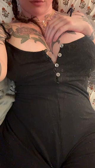 A jiggly reveal: A woman's black dress with a revealing top'