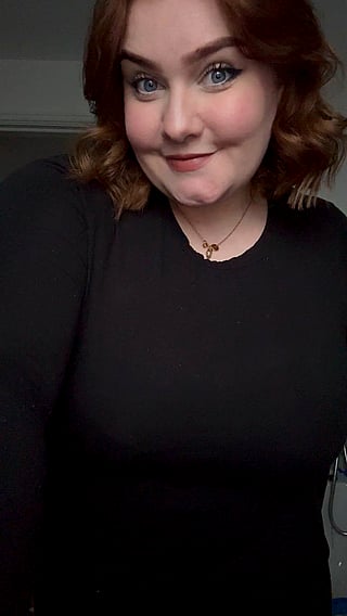 Pretty Woman Takes Selfie in Black Shirt and Necklace'